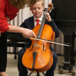 Robin Reinarz teaches a young cello student.